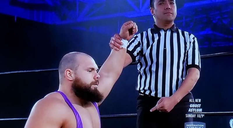 Professional Wrestling Referee Dan Tanaka Raising Michael Elgins Arm